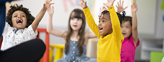 Children with teacher playing with toys