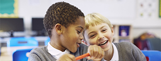 Two primary students enjoying studying together